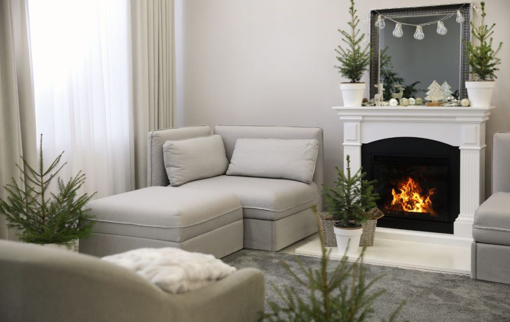 Fireplace Design Ideas: Materials, Colors, Design Styles 14 Seasonal decoration, like pines during winter, are perfect for the fireplace.
